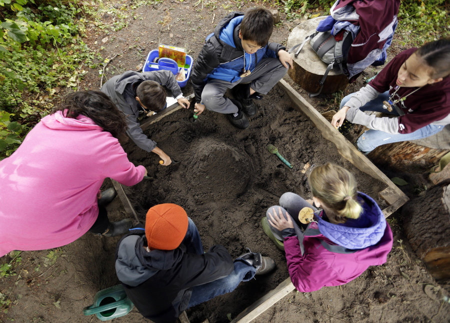 In this Oct. 6, 2016 photo, Outdoor School students work at terraforming a mountain to withstand erosion at Camp Howard in Mount Hood National Forest near Corbett, Ore. The outdoor education is unique to Oregon and is a rite-of-passage for public school students that&#039;s meant to instill a respect for nature in each generation - studies show it improves attendance and boosts test scores.