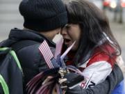 Maureen Valdez, right, cries and hugs another supporter after hearing a verdict outside federal court in Portland, Ore., Thursday, Oct. 27, 2016. A jury exonerated brothers Ammon and Ryan Bundy and five others of conspiring to impede federal workers from their jobs at the Malheur National Wildlife Refuge.