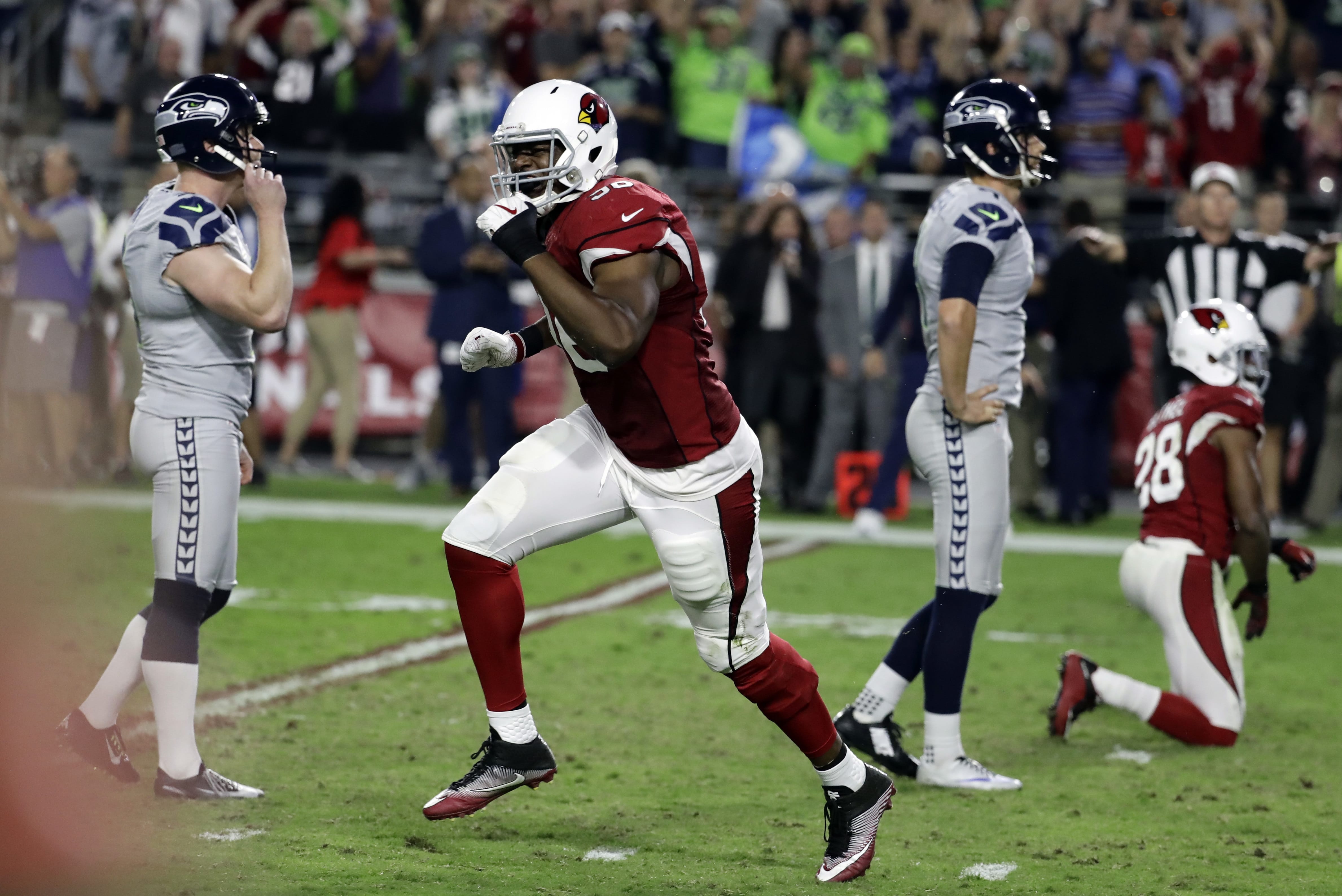 Arizona Cardinals linebacker Kareem Martin, center, reacts to Seattle Seahawks kicker Stephen Hauschka's, left, missed game-winning field goal attempt during overtime an NFL football game against the Arizona Cardinals, Sunday, Oct. 23, 2016, in Glendale, Ariz. The game ended in overtime in a 6-6 tie.