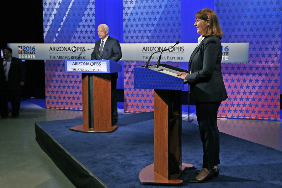 Arizona Democratic Rep. Ann Kirkpatrick, right, and incumbent Republican Sen. John McCain, left, listen to the debate moderators for the debate rules prior to their only scheduled debate before next month&#039;s general election Monday in Phoenix. (AP Photo/Ross D.