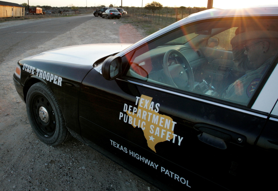 FILE - In this April 6, 2008, file photo, a Texas State Trooper is shown sitting in his vehicle in Eldorado, Texas. Drivers in Texas busted for drunken driving, not paying child support or low-level drug offenses are among thousands of &quot;high-threat&quot; criminal arrests that officials have touted in defense of a nearly $1 billion mission to secure the border with Mexico, an Associated Press analysis has found.