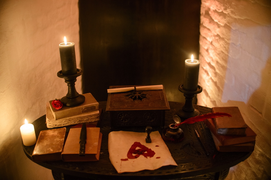 Candles and books are arranged on a table before a photo shoot of a room in Bran Castle, in Bran, Romania on Oct. 9, 2016.
