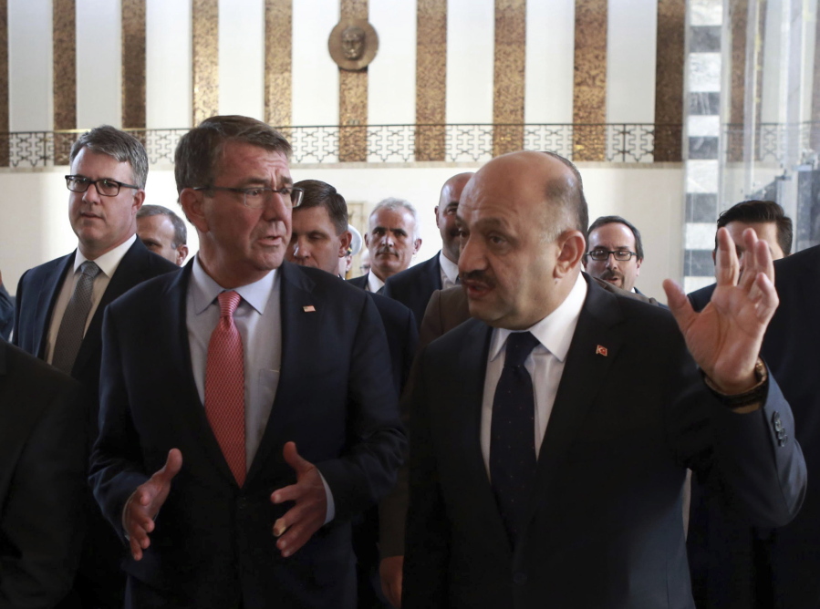 U.S Secretary of Defense Ash Carter, left, speaks to his Turkish counterpart Fikri Isik as he visits Turkish parliament in Ankara, Turkey, Friday, Oct. 21, 2016. Carter met with President Recep Tayyip Erdogan and other top leaders and defense officials in Ankara amid escalating tensions between Turkey and Iraq over Turkish military operations in northern Iraq as allied forces move to retake Mosul from Islamic State militants.