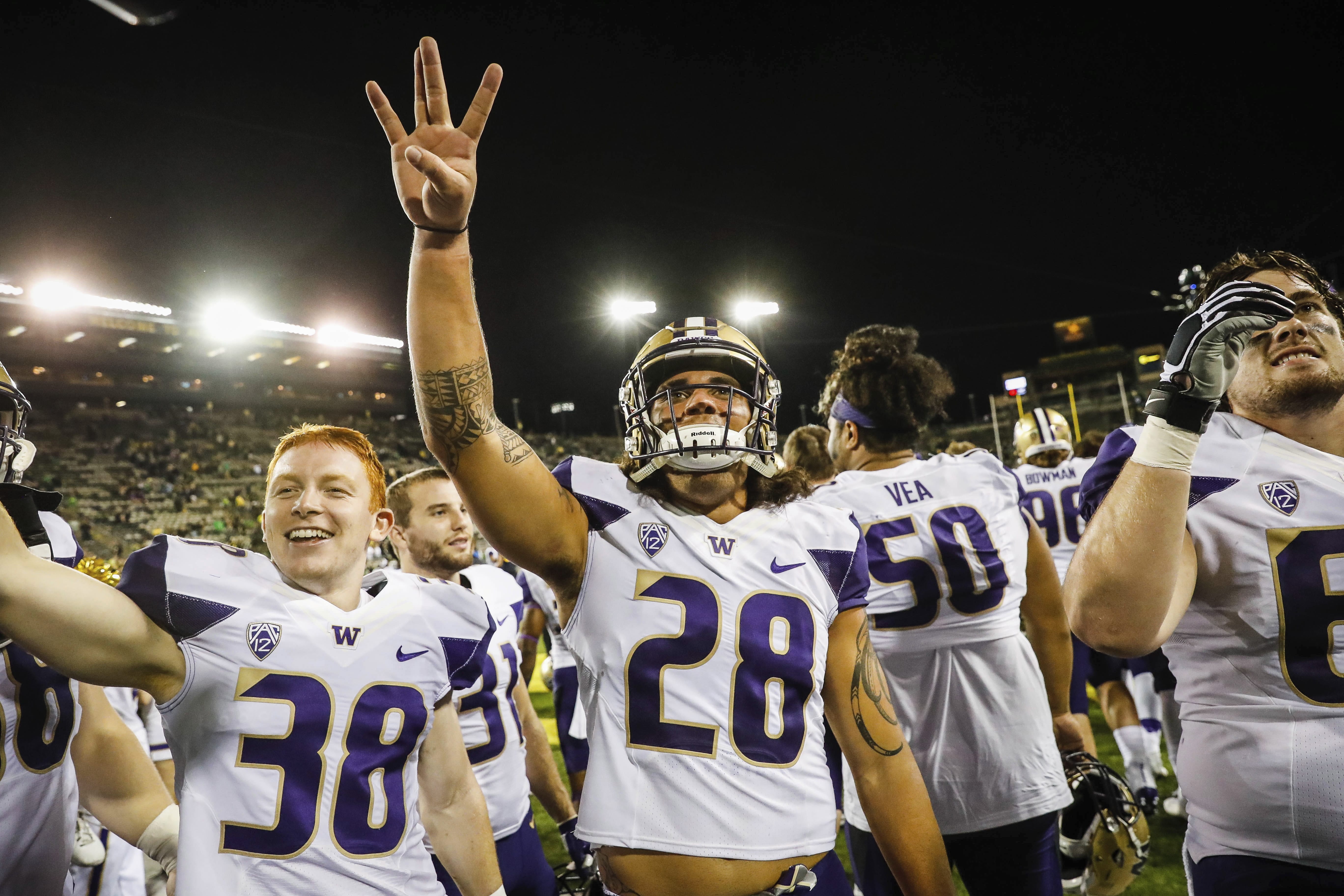 Washington linebacker Psalm Wooching (28) celebrates with his team after an NCAA college football game Saturday, Oct. 8, 2016, in Eugene, Ore. Washington beat Oregon 70-21.