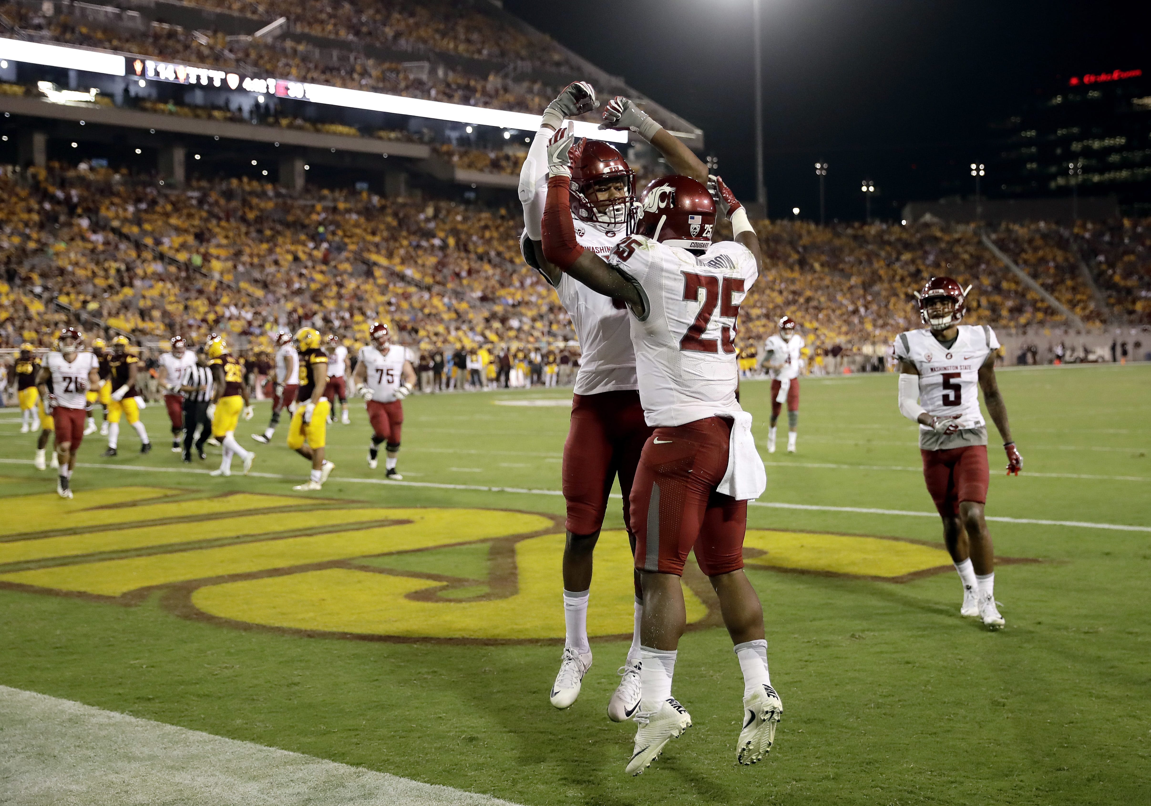 Washington State running back Jamal Morrow (25) celebrates his touchdown catch with teammate Isaiah Johnson-Mack during the second half of an NCAA college football game against Arizona State, Saturday, Oct. 22, 2016, in Tempe, Ariz.