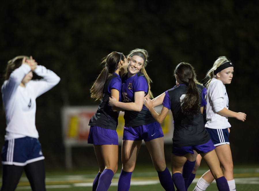 Columbia River's Katie Anthony, facing, celebrates with teammates after she scored the Chieftains' third goal during their Class 2A state semifinal match on Friday, Nov. 18, 2016 at Shoreline Stadium in Shoreline, Wash.