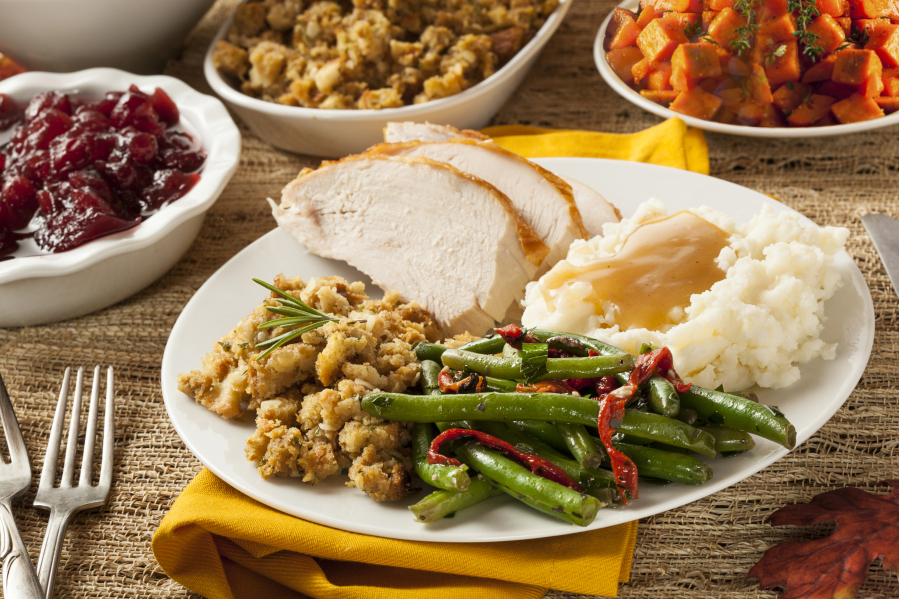 Homemade turkey Thanksgiving dinner with mashed potatoes, stuffing, and green beans.