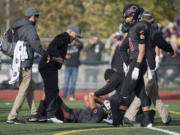 Camas High School receiver Drake Owen lies on the ground after being hit in a state semifinal game against Sumner at McKenzie Stadium on Saturday afternoon, Nov. 26, 2016.