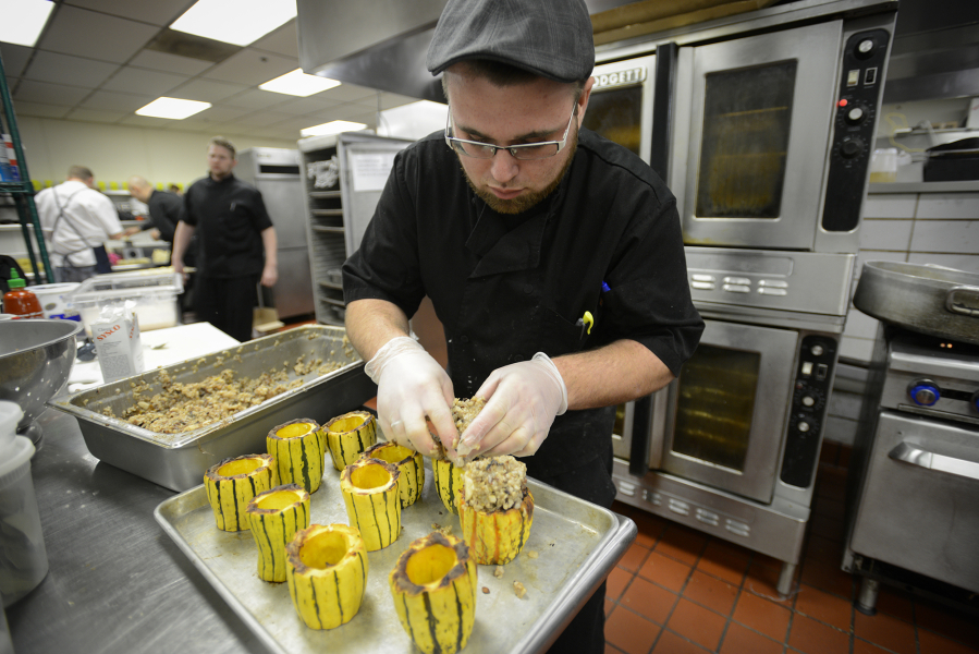 Sous chef Jeff Barham prepares a delicata squash stuffed with rice pilaf and local wild mushrooms in the kitchen at WareHouse '23 in Vancouver in preparation for Taste Renaissance, a fundraising dinner for Slow Foods Southwest Washington earlier this month. The dinner featured local chefs working with locally grown ingredients.