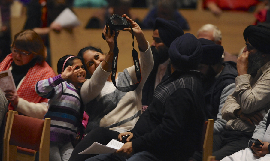 Smita Sethi and her daughter Harliv Sethi take a selfie Wednesday evening prior to the Interfaith Service of Thanksgiving at St. Joseph Catholic Church in Vancouver.