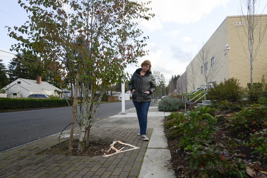Cara Cottingham walks along the deteriorating sidewalk on Fairmount Avenue between East Fourth Plain Avenue and East 20th Street, where part of the sidewalk has deteriorated to a point where people in wheelchairs can&#039;t use them.
