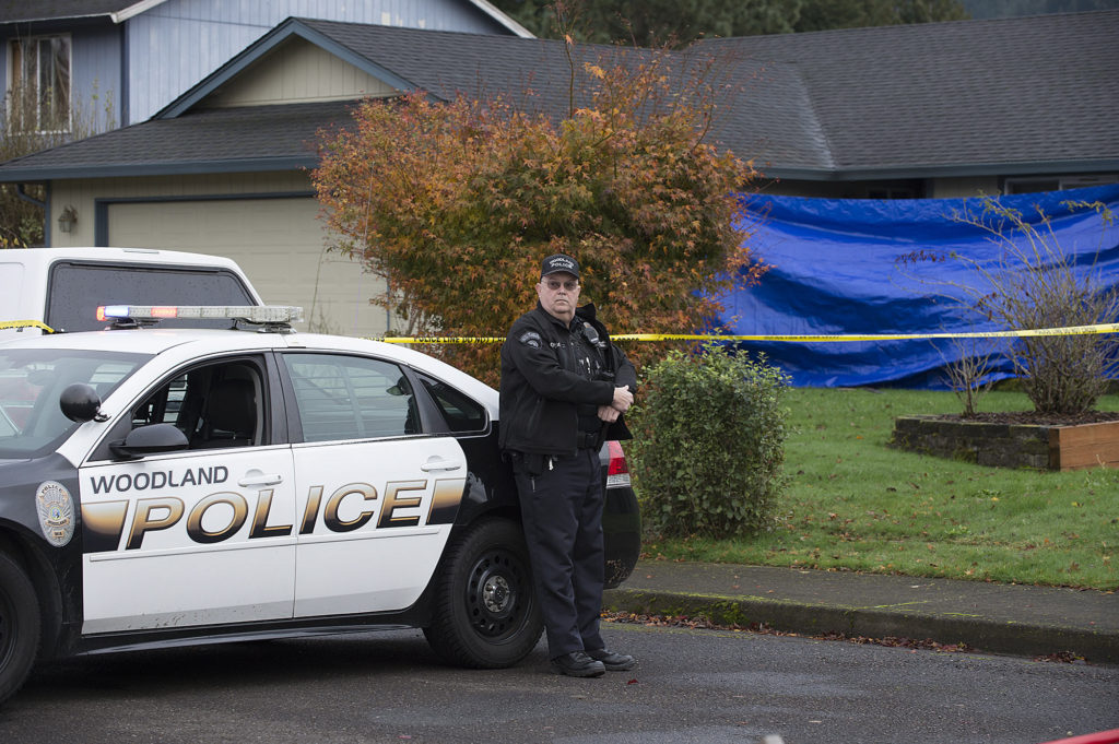 Officer Rudy Podhora keeps watch at the scene of a homicide in Woodland on Nov. 22, 2016.  Dustin Alan Griffin was arrested on suspicion of first degree murder in the death of Donald William Howard.