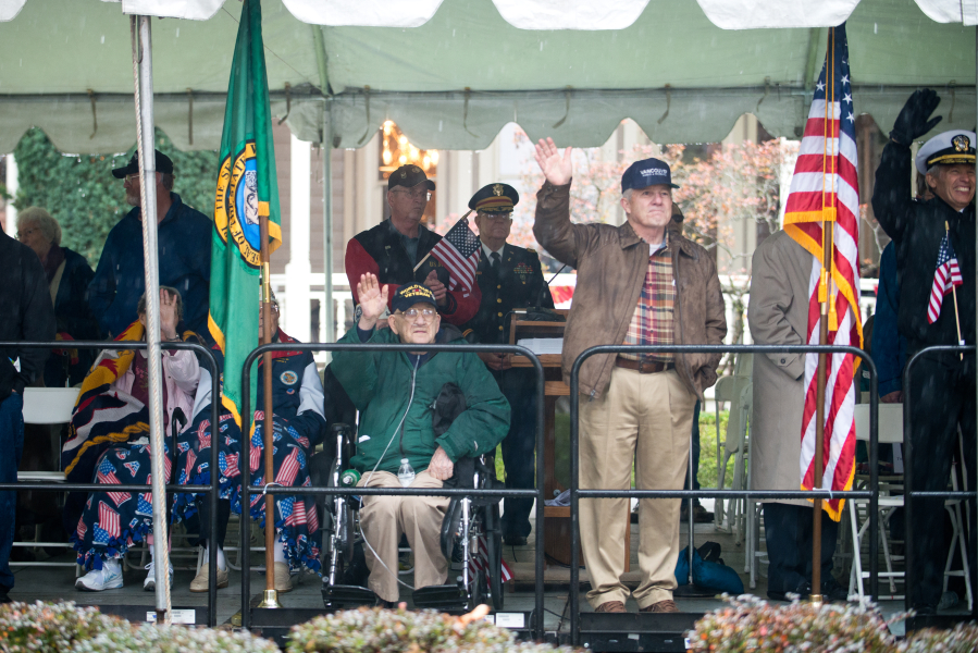 Veterans and their families wave as the Lough Legacy Veterans Parade at Fort Vancouver passes by in 2015. (Molly J.