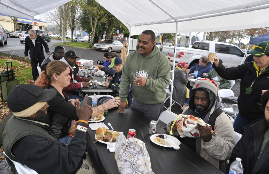 Donnie Vercher, center, said food brings people together, which is why when he wanted to give back to the community he decided to host a free Thanksgiving meal for the homeless. His fifth annual meal, which took place on Saturday, saw more than 400 people come to his restaurant, Daddy D&#039;s BBQ, located in the back of a gas station.