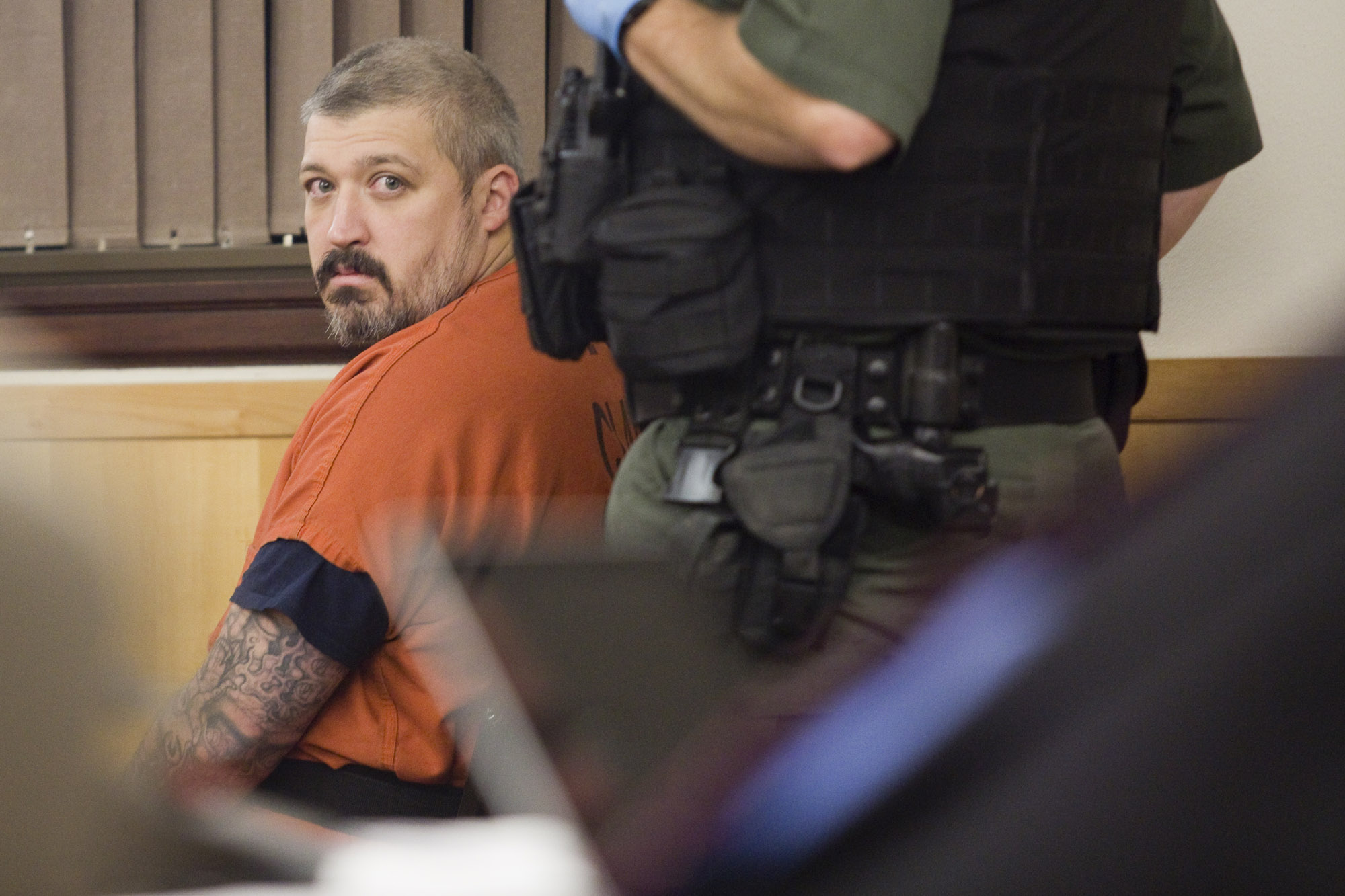 Brent Luyster, the man accused in the Woodland triple-homicide, waits to be called forward during his hearing Tuesday, Nov. 8 in Clark County Superior Court. Luyster's arraignment was pushed back for a third time Tuesday.