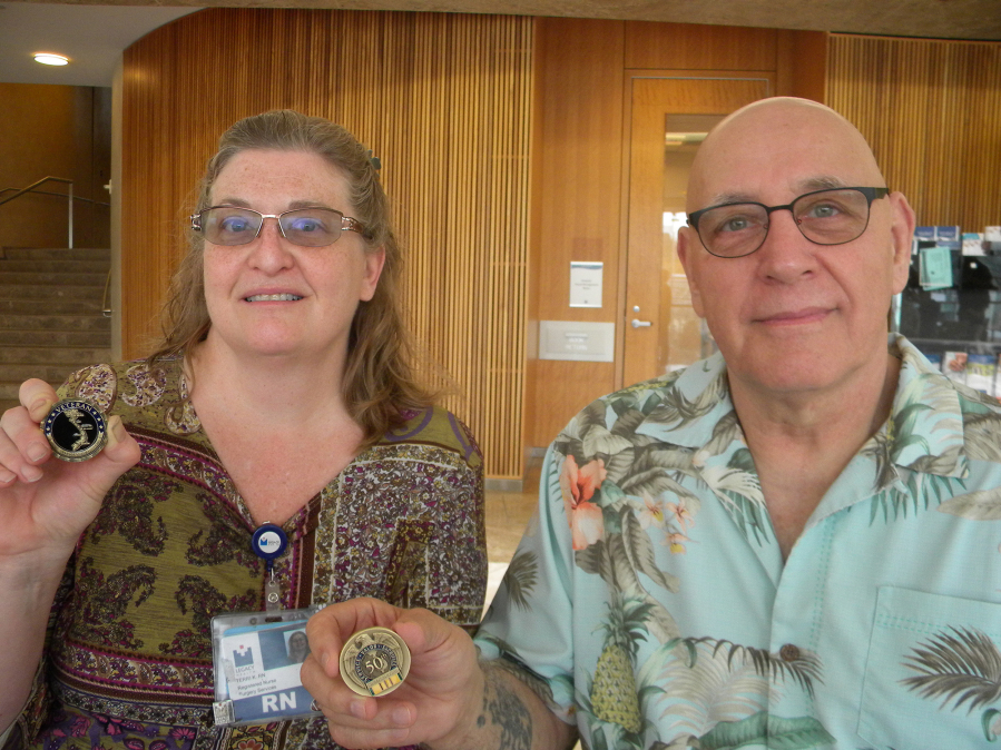 Recovery room nurse Terri Kramer, left, and Steven Jimerfield, a recent patient at Legacy Salmon Creek Medical Center, with commemorative coins.