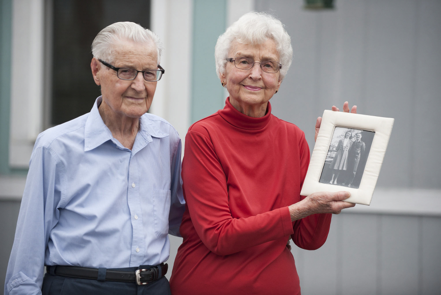 Lowell and Eleanor Lawry recall their early years together while looking at a photo taken of them in 1942, a year after their wedding. The Lawrys will celebrate their 75th wedding anniversary in December.