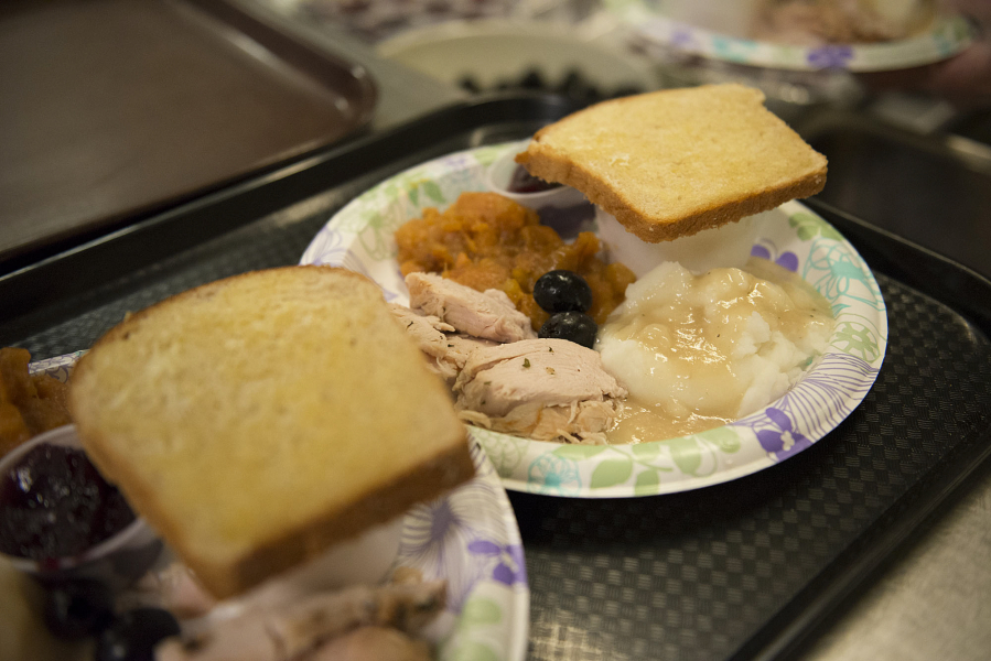 Classic dishes fill plates at a free Thanksgiving 2015 supper at the Proto-Cathedral of St. James, 218 W. 12th St., Vancouver. The church offers a free meal every Thursday evening in honor of Blessed Pier Giorgio Frassati.