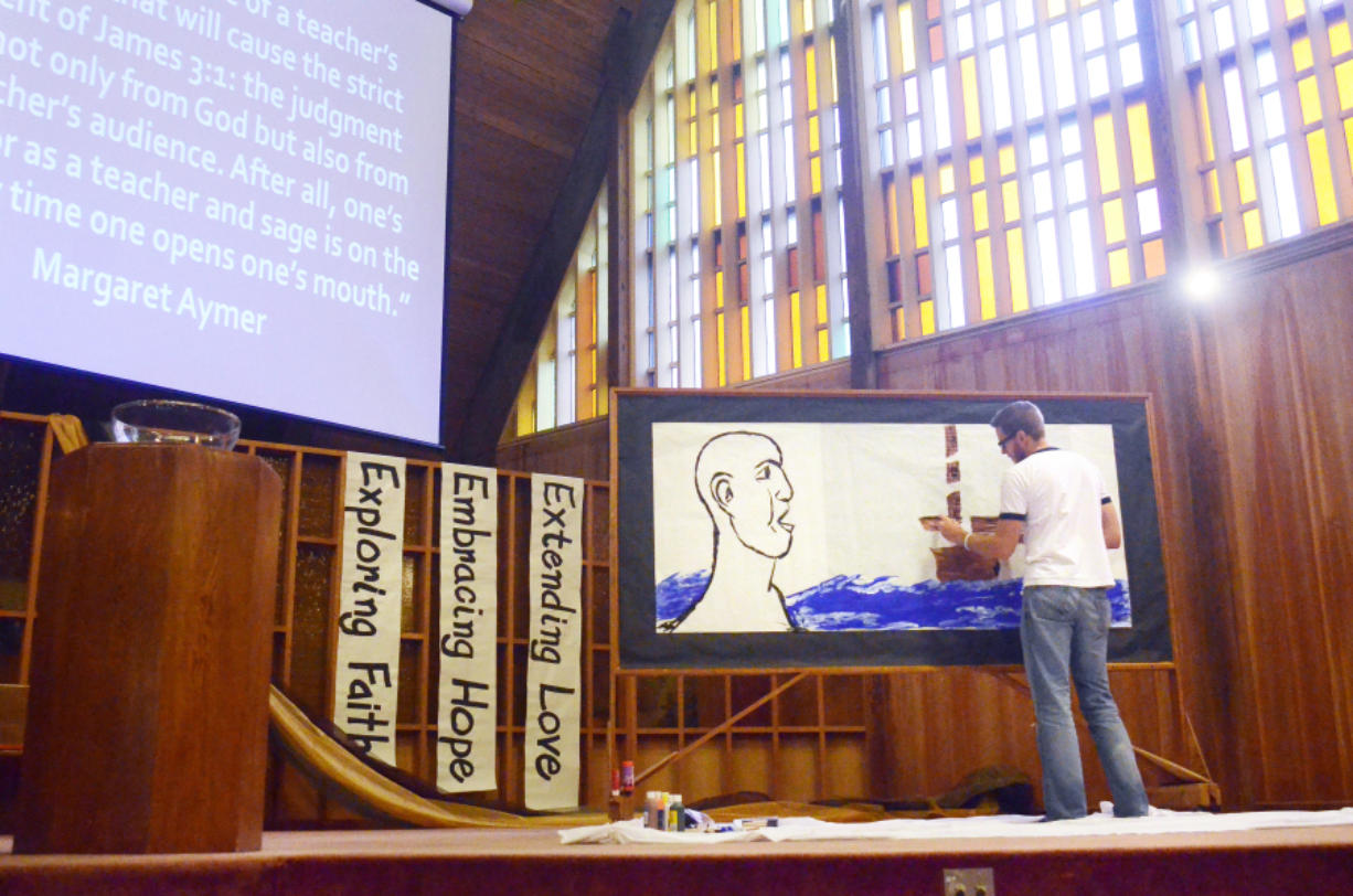 Vancouver art teacher Jeffrey Thompson paints a picture before the congregation at First Presbyterian Church in Vancouver on Oct. 16. Thompson and Rev. Josh Rowley collaborated for the fourth time to illustrate a sermon as it is preached.
