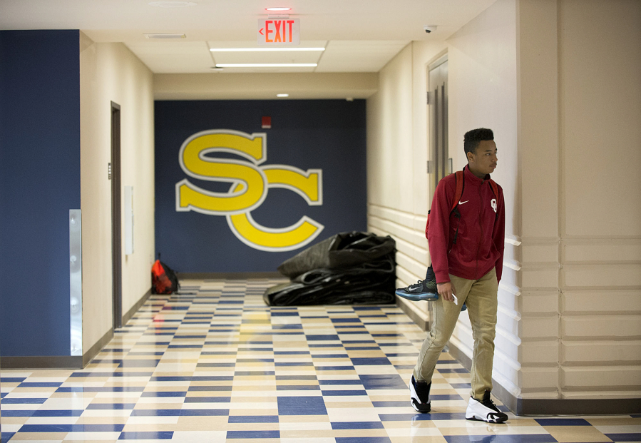 Freshman Tyvauntae Delony, 15, walks through a hallway at Seton Catholic College Preparatory High School on Tuesday morning. After seven years in a much smaller space, the school unveiled its new campus this fall.