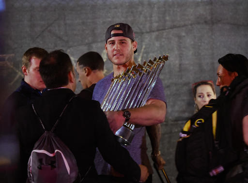 Chicago Cubs first baseman Anthony Rizzo displays the Commissioner's Trophy as the team arrives at Wrigley Field in Chicago early Thursday, Nov. 3, 2016, after the Cubs defeated the Cleveland Indians 8-7 in Game 7 of the baseball World Series in Cleveland.