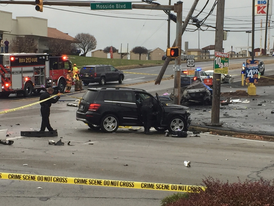 Police investigate the scene of a crash at the intersection of Route 30 and Route 48, Thursday, Nov. 24, 2016, in North Versailles, Pa. Police say a man who led them on a car chase and caused a fiery crash that killed three people near Pittsburgh had been wanted in a drug case. East McKeesport police Chief Russell Stroschein says the driver headed into North Versailles, ran a red light and hit two cars, killing three people in one of them.