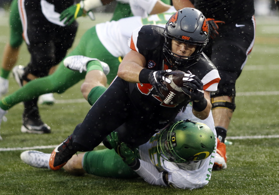 Oregon State running back Ryan Nall, top, dives over Oregon&#039;s Danny Mattingly for a touchdown in the second half an NCAA college football game in Corvallis, Ore., Saturday Nov. 26, 2016. (AP Photo/Timothy J.