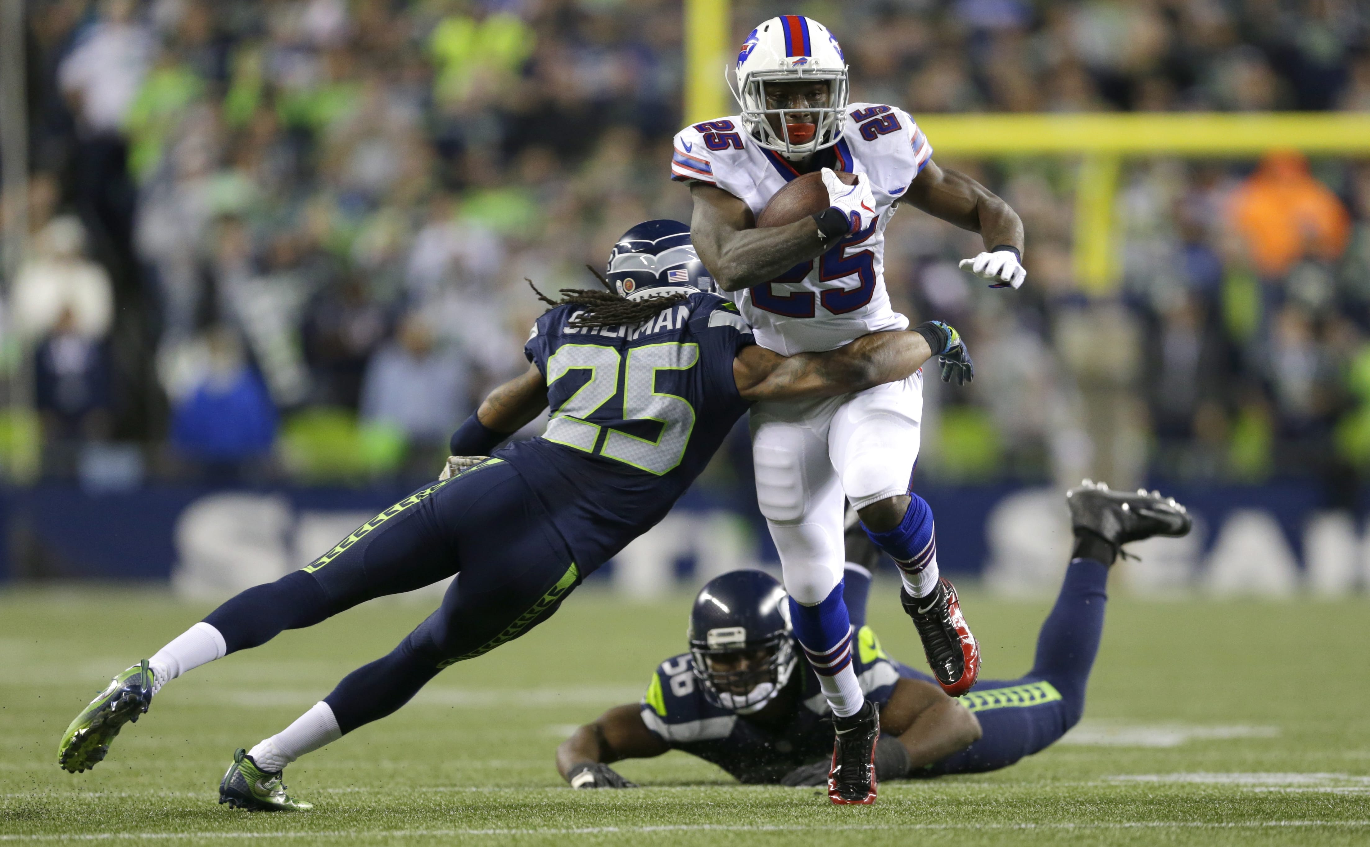 Seattle Seahawks cornerback Richard Sherman, left, tackles Buffalo Bills running back LeSean McCoy after McCoy got past Seahawks' defensive end Cliff Avril, bottom, in the second half of an NFL football game, Monday, Nov. 7, 2016, in Seattle.