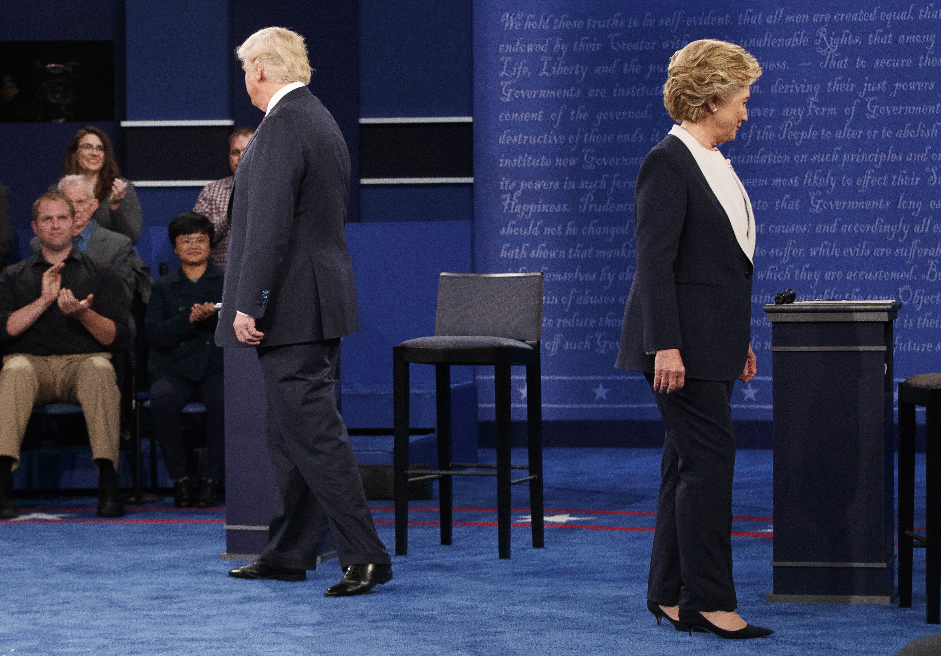 Republican presidential candidate Donald Trump, left, and Democratic presidential candidate Hillary Clinton walk to their chairs as they arrive for the second presidential debate at Washington University in St. Louis. Andrew Cullison, a professor at DePauw University in Indiana who is studying skepticism and its relation to contemporary politics, says the internet has allowed lies to gain traction and for people to insulate themselves from those who disagree. He says controlled studies have found that, even when provided evidence that something is false, many simply double-down and increase their level of confidence in a belief's validity.