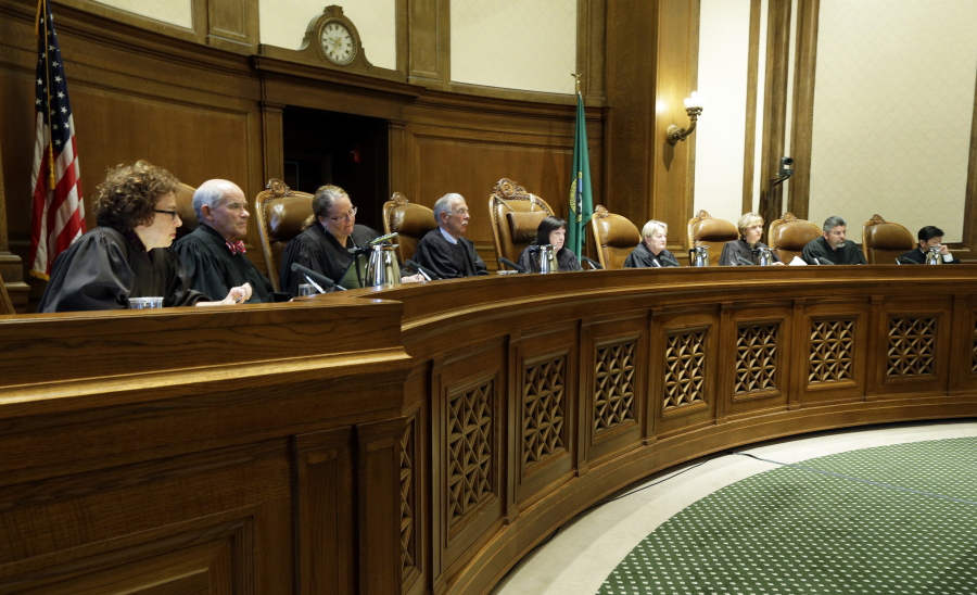 Justices on the Washington state Supreme Court listen Sept. 7, 2016, during a hearing in Olympia.  (Ted S.