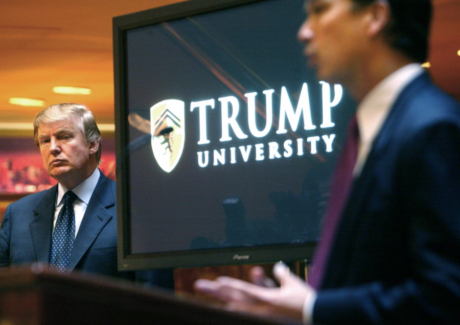 Donald Trump listens May 23, 2005, at left as Michael Sexton introduces him at a news conference in New York where he announced the establishment of Trump University. Among the people with serious financial problems who taught for Trump University is a case that crossed international borders, an Ontario couple who securities regulators sanctioned over a multimillion-dollar fraud, according to documents reviewed through a joint investigation by The Associated Press and The Canadian Press.