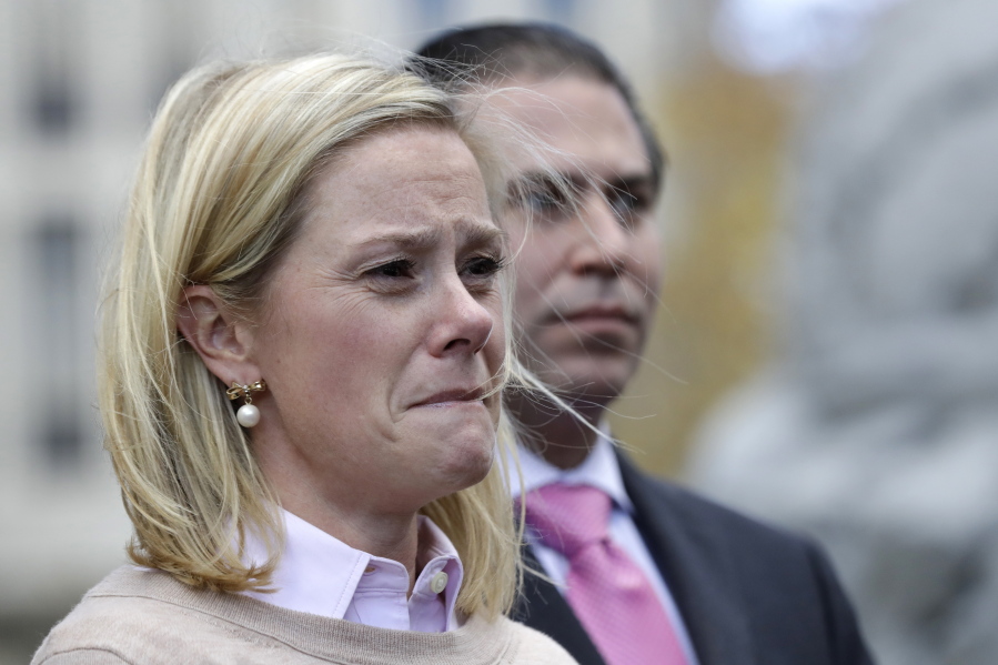 Bridget Anne Kelly, former deputy chief of staff for New Jersey Gov. Chris Christie, listens as her lawyer Michael Critchley talks to reporters after Friday&#039;s verdict.