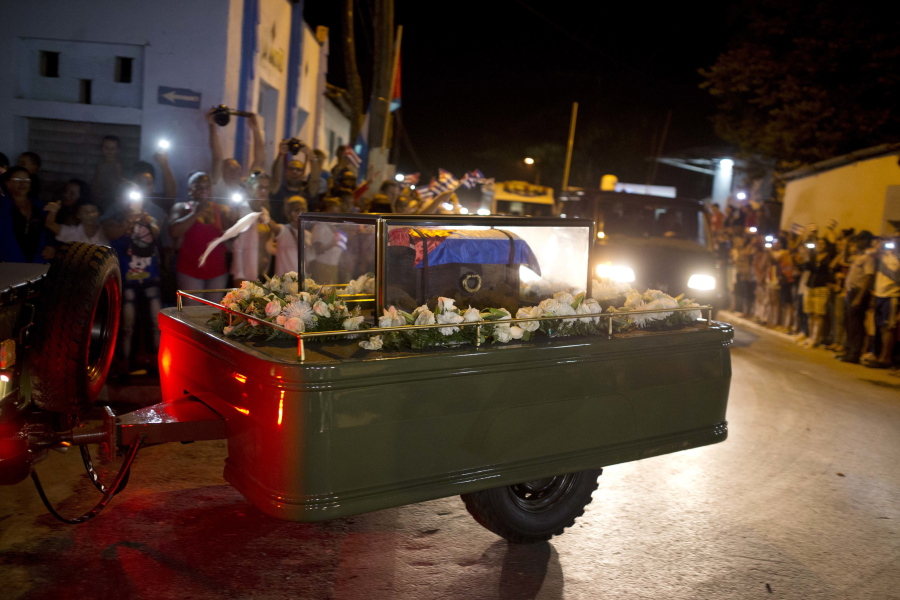 A trailer carries a small coffin, covered by a Cuban flag, that contains the ashes of Fidel Castro during a funeral procession Wednesday in La Esperanza, Cuba.