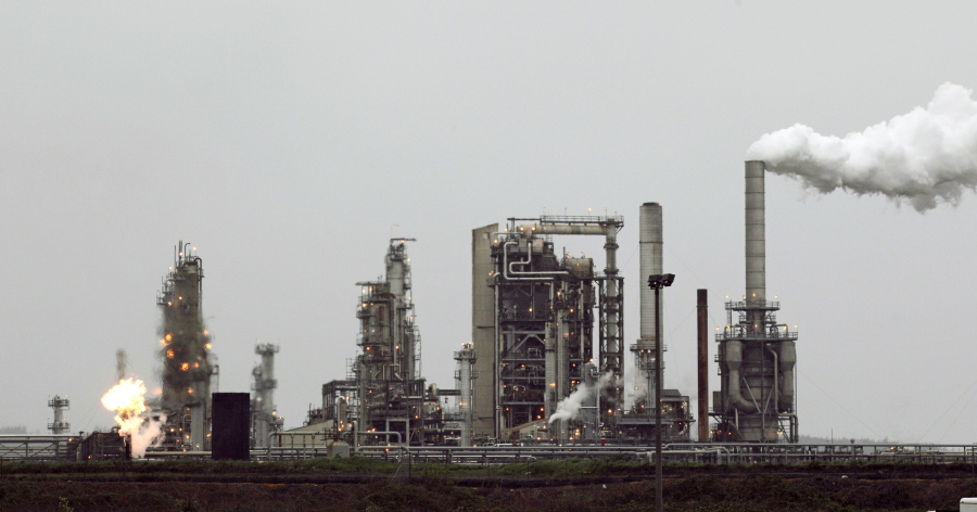 The gas flare flame and smoke are part of normal plant operations in 2010 at a Tesoro Corp. refinery in Anacortes. (Ted S.