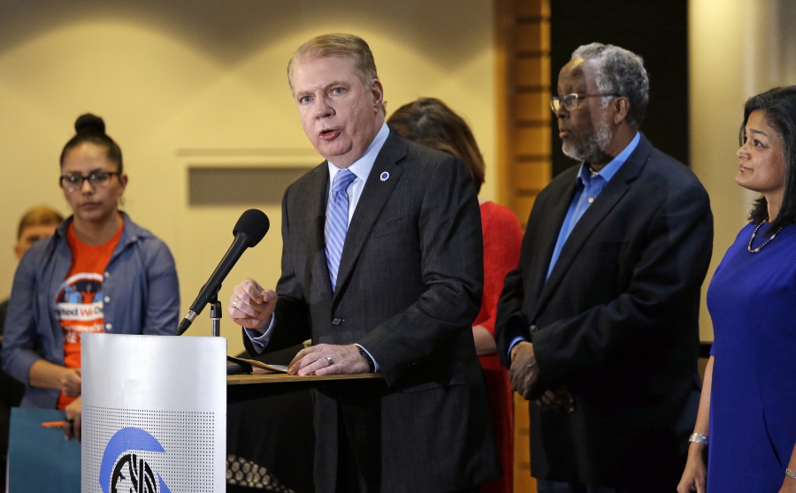 Seattle Mayor Ed Murray, second left, speaks at a post-election event of elected officials and community leaders Wednesday at City Hall in Seattle.