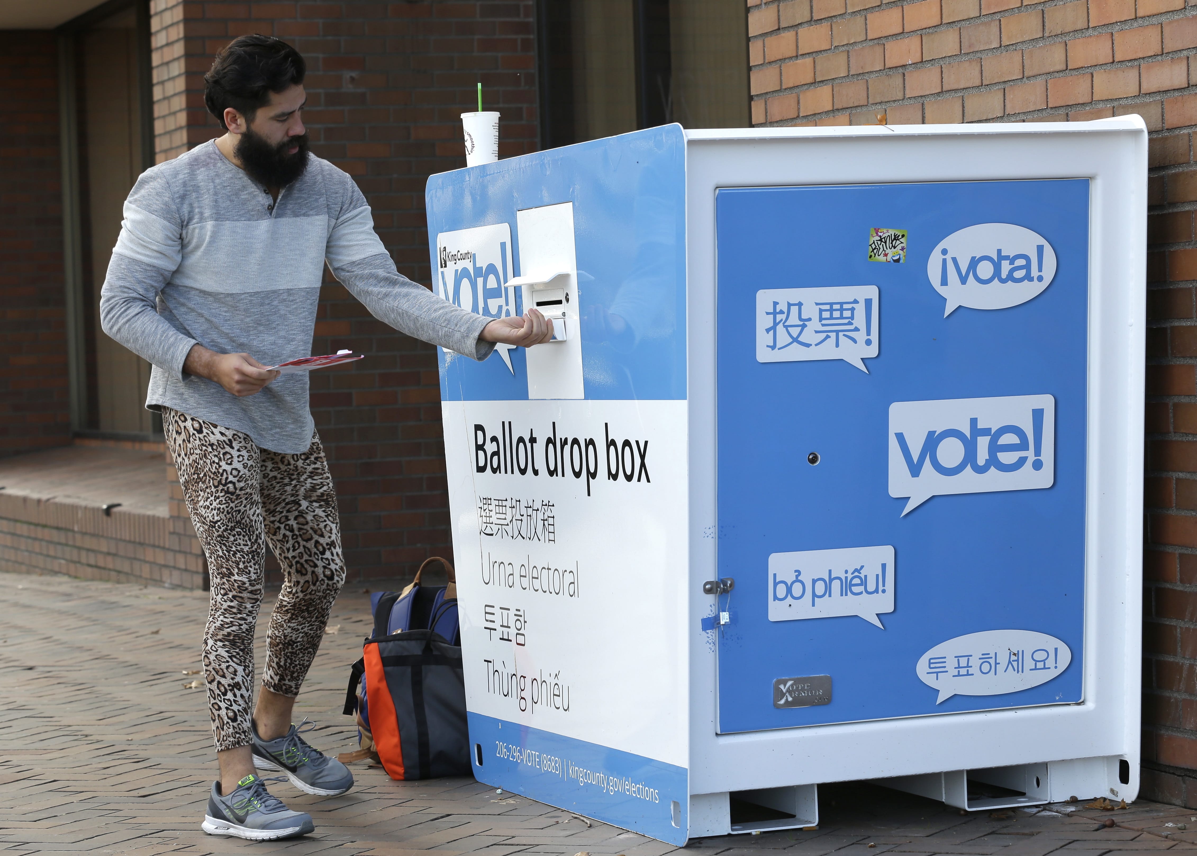 Jared Keirn deposits his vote-by-mail ballot in a collection box, Thursday, Nov. 3, 2016, at Seattle Central College in Seattle. More than a million Washingtonians have already cast their ballots in advance of Tuesday's election, as voters decide on federal and state races, as well as ballot initiatives. (AP Photo/Ted S.