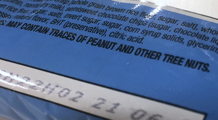 This Nov. 30, 2016, photo shows part of a food label that states the product &quot;may contain traces of peanut and other tree nuts&quot; as photographed in Washington. A new report says the hodgepodge of warnings that a food might accidentally contain a troublesome ingredient is confusing to people with food allergies, and calls for a makeover. The report from the prestigious National Academies of Sciences, Engineering and Medicine said it&#039;s time for regulators and the food industry to clear consumer confusion with labels that better reflect the level of risk.