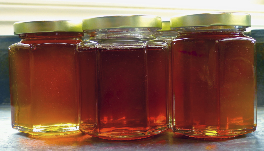 Jars of raw honey from honeybee hives on a small orchard near Langley make a thoughtful holiday gift.