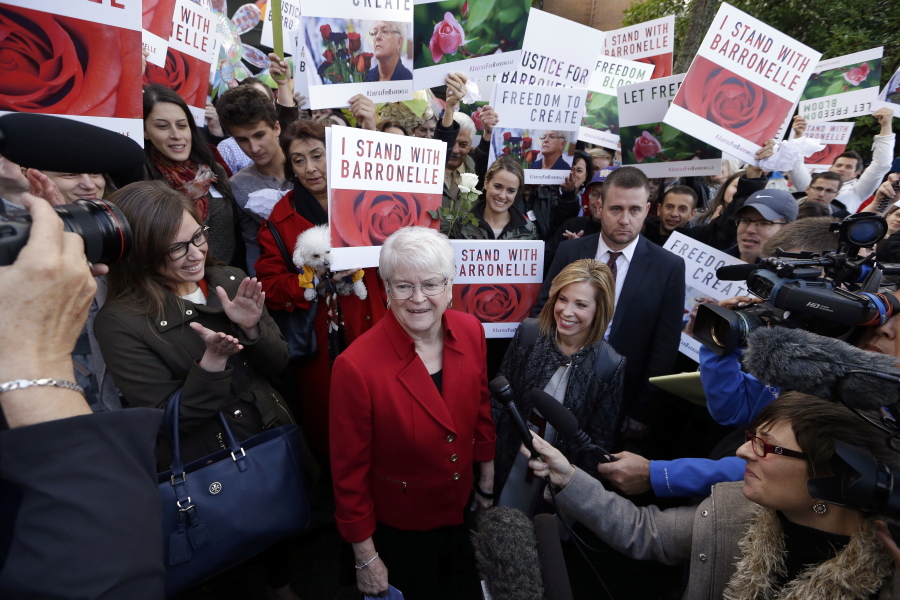 Barronelle Stutzman, center, a Richland, Wash., florist who was fined for denying service to a gay couple in 2013, smiles as she is surrounded by supporters after a hearing before Washington&#039;s Supreme Court on Tuesday in Bellevue. Stutzman was sued for refusing to provide services for a same sex-wedding and says she was exercising her First Amendment rights, but justices questioned whether ruling in her favor would mean other businesses could turn away customers based on racial or other grounds.