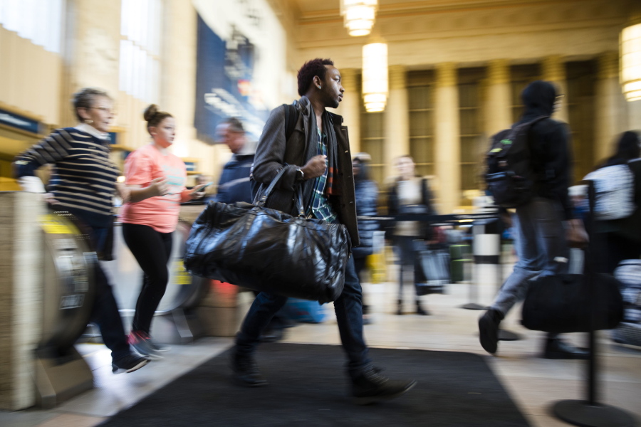 Travelers make their way through the 30th Street Station ahead of the Thanksgiving Day holiday, in Philadelphia, Tuesday, Nov. 22, 2016. Almost 49 million people are expected to travel 50 miles or more for the holiday, the most since 2007, according to AAA.