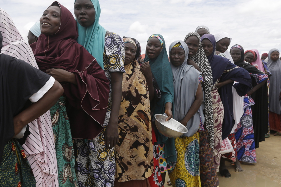 Women displaced by Islamist extremists wait for food to be handed out to them at the Bakassi camp in Maiduguri, Nigeria. Many say the dangerous journey is preferable to the hunger, humiliation and inhumane conditions in refugee camps where more than 1 million Nigerians, displaced by Boko Haram, are waiting to go home. Many are in Maiduguri, the biggest city in the northeast, the birthplace of Boko Haram, which has killed more than 20,000 and forced 2.6 million from their homes.