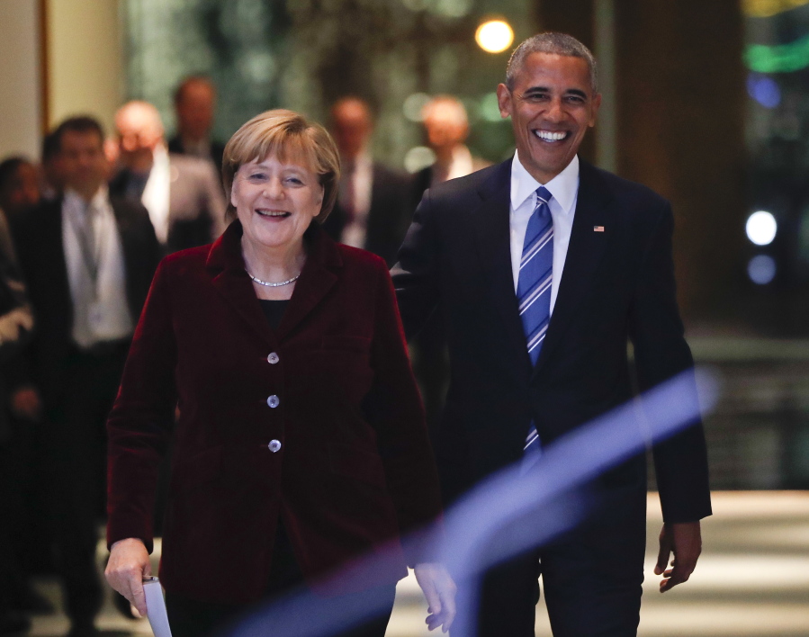 President Barack Obama and German Chancellor Angela Merkel smile as they arrive for their joint news conference at the German Chancellery in Berlin on Thursday.