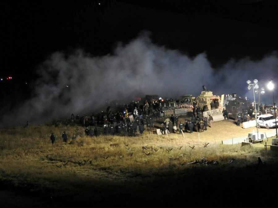 Law enforcement and protesters clash near the site of the Dakota Access pipeline on Sunday in Cannon Ball, N.D. The clash came as protesters sought to push past a bridge on a state highway that had been blockaded since late October, according to the Morton County Sheriff&#039;s Office.