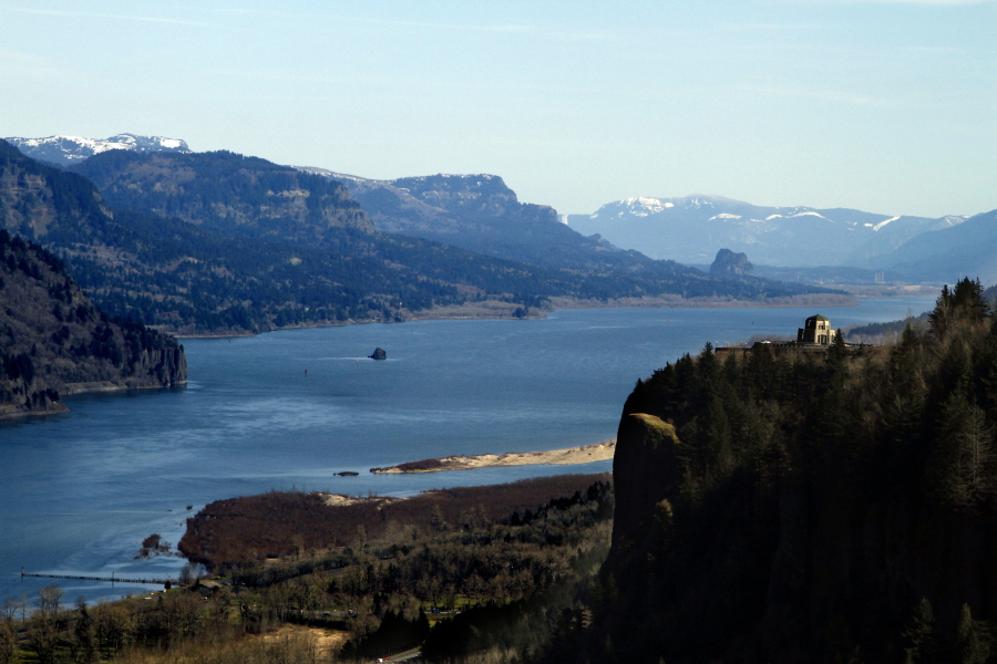 The Columbia River flows past the Vista House on Crown Point, right, with Beacon Rock visible in the distance near Corbett, Ore. Oregon is expecting a record number of visits to its state parks and federal lands for the second year in a row. Data from multiple agencies shows that the crowds began growing in 2013 and show no signs of slowing down.