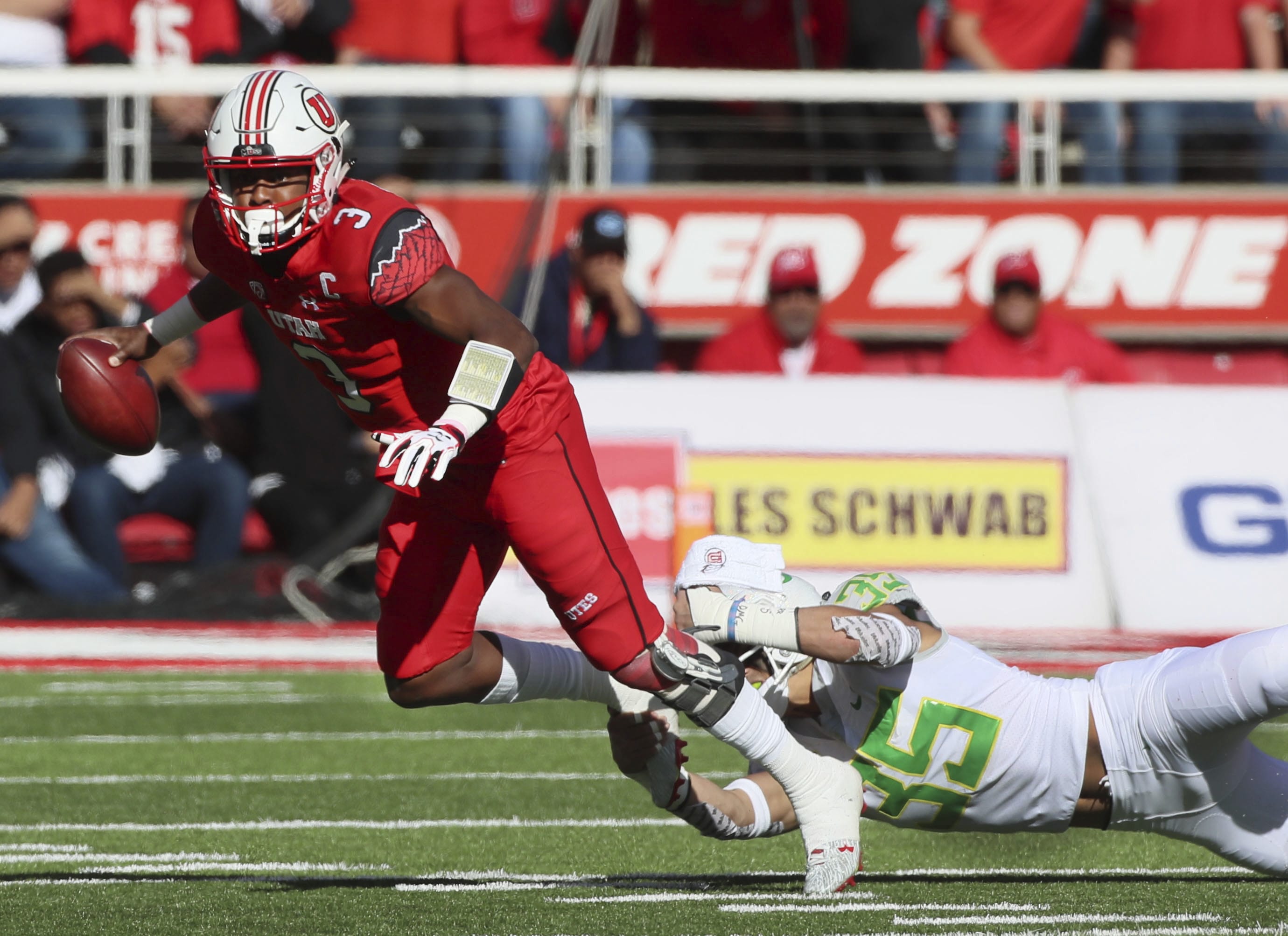 Oregon linebacker Troy Dye (35) dives and sacks Utah quarterback Troy Williams (3) in the first half of an NCAA college football game, Saturday, Nov. 19, 2016, in Salt Lake City.