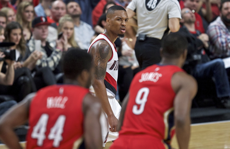 Portland Trail Blazers guard Damian Lillard looks toward the New Orleans Pelicans bench after scoring a 3-point basket during the second half of an NBA basketball game in Portland, Ore., Friday, Nov. 25, 2016.