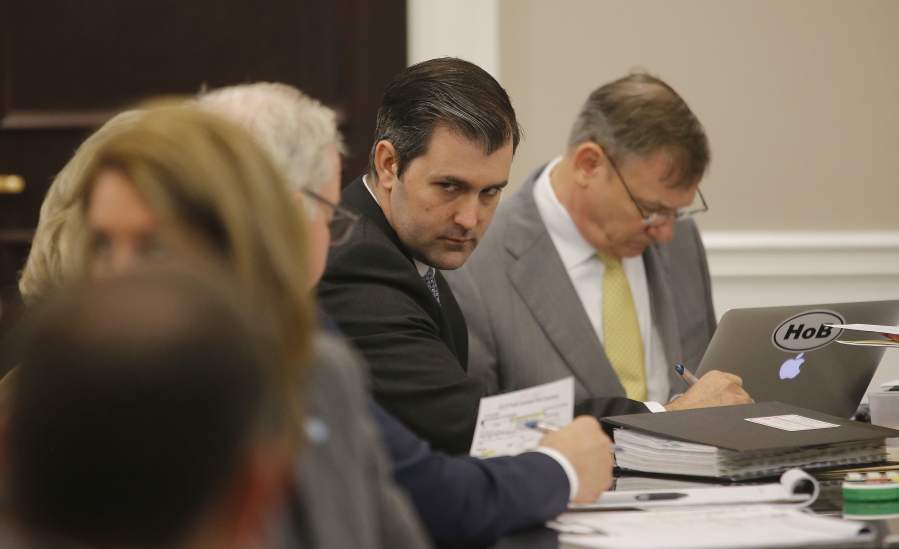 Former North Charleston Police Officer Michael Slager, second from right, sits at the defense table and listens to his lawyer in the courtroom Thursday in Charleston, S.C. Slager faces 30 years to life if convicted of murder in the April 2015 death of Scott, whose shooting, captured on a bystander&#039;s dramatic cellphone video, spread on social media and stunned the nation.