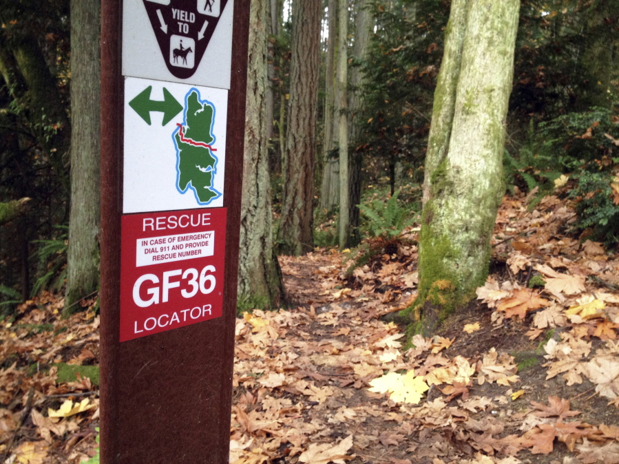 A trail locator in the 240-acre Grand Forest on Bainbridge Island is one of about 30 labeled by the Bainbridge park district to help emergency responders find injured trail users.