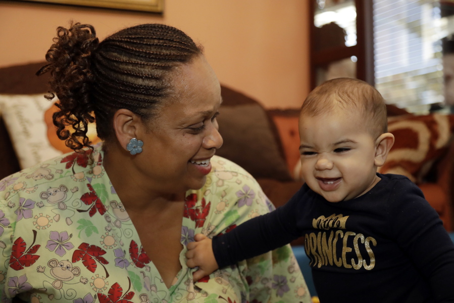 Nancy Harvey, owner of Lil&#039; Nancy&#039;s Primary Schoolhouse in Oakland, Calif., cares for a toddler last month at her home, which has she has converted into a child care center. Harvey said she has less than $2,000 saved for retirement despite her decades of work.