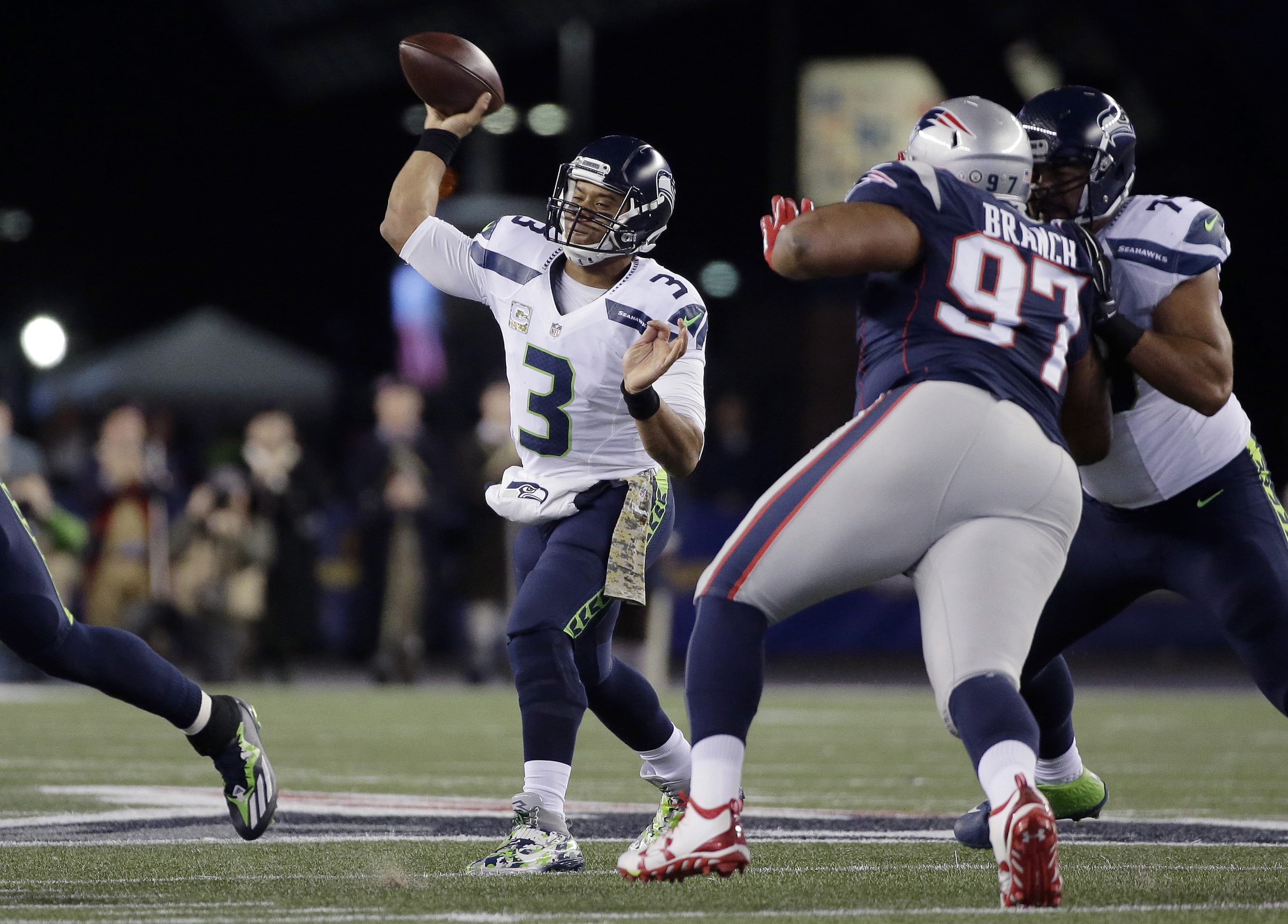 Seattle Seahawks quarterback Russell Wilson (3) passes under pressure by New England Patriots defensive lineman Alan Branch (97) during the first half of an NFL football game, Sunday, Nov. 13, 2016, in Foxborough, Mass.